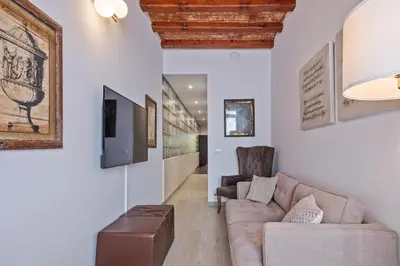 a living room with a couch and a chair at Alcam Books in Barcelona