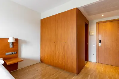 a bedroom with a large wooden closet and a bed at Onix Rambla in Barcelona