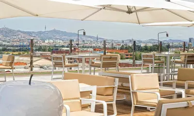 a view from the roof of a restaurant with tables and chairs at Salles Ciutat del Prat Barcelona Airport in El Prat de Llobregat