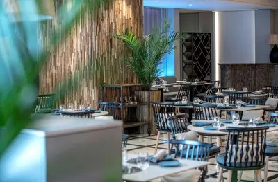 a restaurant with tables and chairs in a room at Sallés Hotel Pere IV in Barcelona