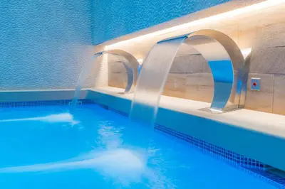 a swimming pool with two water faucets in it at Sallés Hotel Pere IV in Barcelona