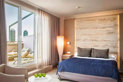 a hotel room with a bed and a large window at Sallés Hotel Pere IV in Barcelona