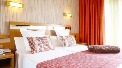 a hotel room with a bed with two pillows at Sumus Hotel Stella and Spa 4S Adults Recommended in Pineda de Mar