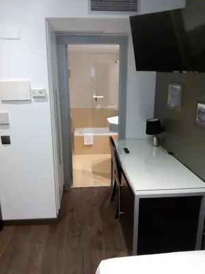 a room with a bathroom with a sink and a tub at Moderno in Barcelona