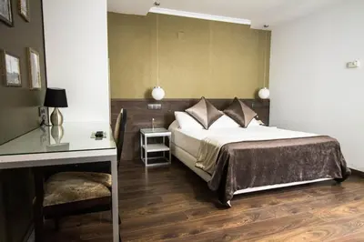 a bedroom with a bed and a table and a desk at Moderno in Barcelona
