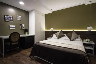 a bedroom with a bed and a desk and a chair at Moderno in Barcelona
