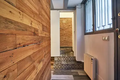 a wooden wall in the hallway of a house at BBarcelona Dúplex Poble Sec in Barcelona