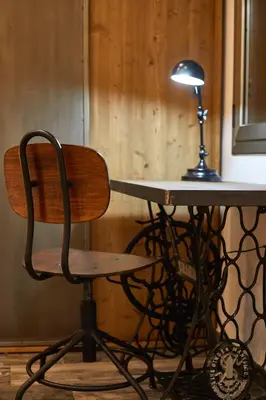 a desk with a chair next to a table with a lamp at BBarcelona Dúplex Poble Sec in Barcelona