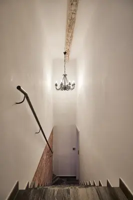 a staircase with a chandelier in a building at BBarcelona Dúplex Poble Sec in Barcelona
