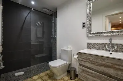 a bathroom with a toilet and a shower and a sink at BBarcelona Dúplex Poble Sec in Barcelona