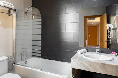 a bathroom with a tub and a sink and a toilet at Catalunya in Barcelona