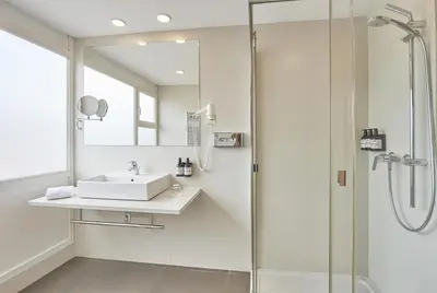 a bathroom with a sink and a shower at NH Barcelona Stadium in Barcelona