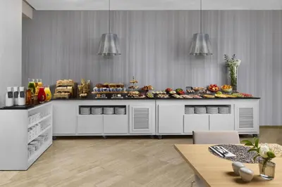 a kitchen with a counter with food on it at NH Barcelona Stadium in Barcelona