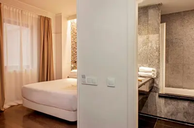 a hotel room with a bed and a bathroom at Chic & Basic Velvet in Barcelona