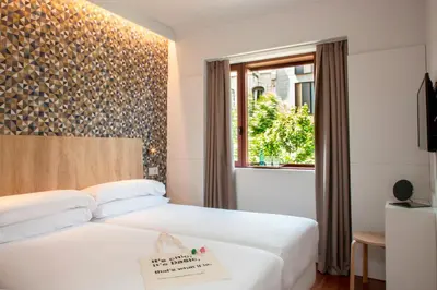 a hotel room with a bed with a sign on it at Chic & Basic Velvet in Barcelona