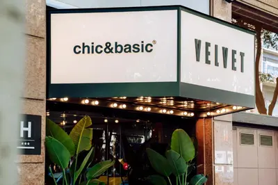 a sign for a restaurant with lights on it at Chic & Basic Velvet in Barcelona