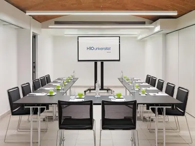 a conference room with a long table and chairs at H10 Universitat in Barcelona