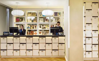 two people standing behind a counter in a store at H10 Universitat in Barcelona