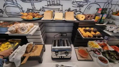 a buffet with lots of different types of bread and pastries at Evenia Rossello in Barcelona