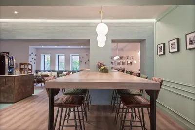 a dining room with a large wooden table and chairs at Hotel Via Augusta in Barcelona