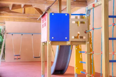 a play room with a climbing frame and a slide at Sunway Playa Golf & Spa Sitges in Sitges