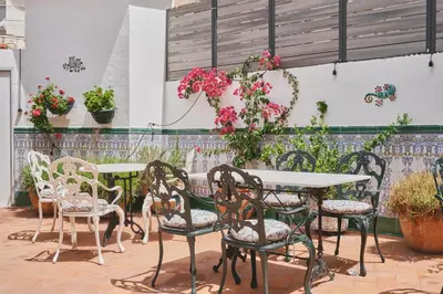 a patio with a table and chairs and flowers at Mesón Castilla Atiram Hotels in Barcelona