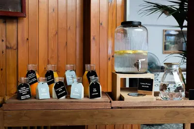 a wooden table with a bunch of bottles of perfume at Mesón Castilla Atiram Hotels in Barcelona