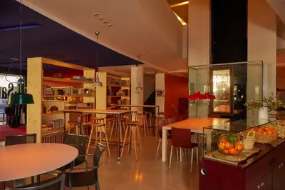 a restaurant with tables and chairs and a bar at El Sant Cugat, 4 estrellas superior in Sant Cugat del Vallès