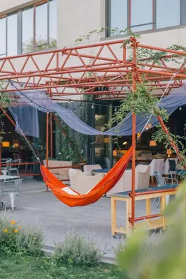 an orange hammock in front of a building at El Sant Cugat, 4 estrellas superior in Sant Cugat del Vallès