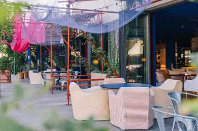 a group of chairs and tables in front of a restaurant at El Sant Cugat, 4 estrellas superior in Sant Cugat del Vallès