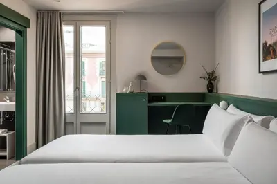 a hotel room with a bed and a desk at BYPILLOW Mothern in Barcelona