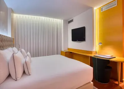 a hotel room with a bed and a tv at Sansi Pedralbes in Barcelona