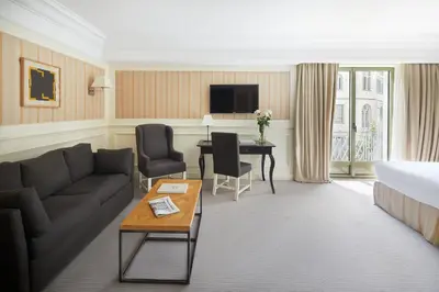 a hotel room with a couch and a bed and a desk at Majestic Hotel & Spa Barcelona GL in Barcelona