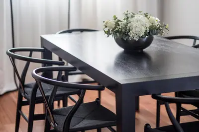 a black table with a vase of flowers on it at Majestic Hotel & Spa Barcelona GL in Barcelona
