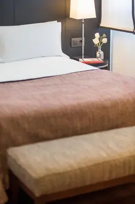 a bedroom with a bed and a table with a lamp at Majestic Hotel & Spa Barcelona GL in Barcelona