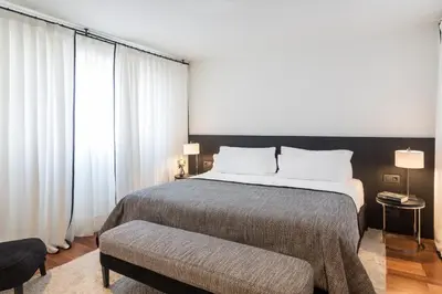 a bedroom with a large bed and a large window at Majestic Hotel & Spa Barcelona GL in Barcelona