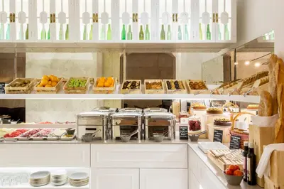 a kitchen filled with lots of food on display at Hotel Midmost by Majestic Hotel Group in Barcelona