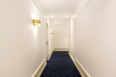 a bedroom with a bed and a desk and a couch at Hotel Midmost by Majestic Hotel Group in Barcelona