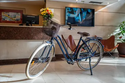 a blue bike parked in a lobby with flowers at Sunotel Junior in Barcelona