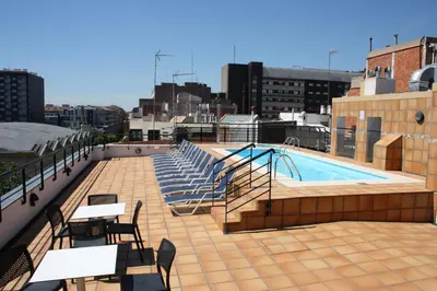 a balcony with a swimming pool on top of a building at Sunotel Junior in Barcelona