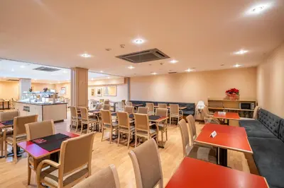 a restaurant with tables and chairs and a bar at Sunotel Junior in Barcelona