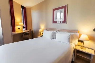 a bedroom with a large white bed with two lamps at Sunotel Junior in Barcelona
