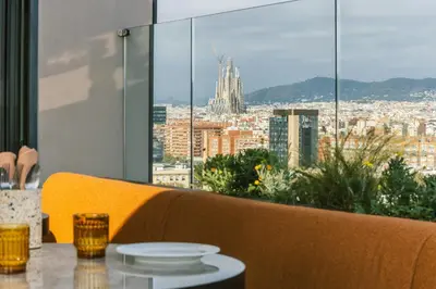 a living room with a couch and a table and chairs at The Social Hub Barcelona Poblenou in Barcelona