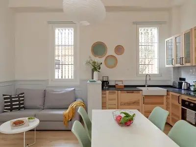 a kitchen and living room with a couch and a table at Casa Cosi Patio 1 in Barcelona