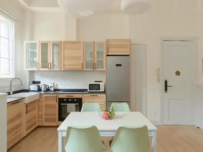 a kitchen with a white table and chairs in a room at Casa Cosi Patio 1 in Barcelona