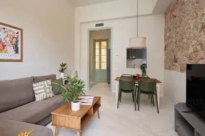 a living room with a couch and a table at Casa Cosi Don Bajos in Barcelona