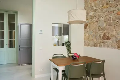 a dining room with a wooden table and chairs at Casa Cosi Don Bajos in Barcelona