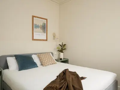 a bedroom with a white bed with a blanket on it at Casa Cosi El Farro 4 in Barcelona