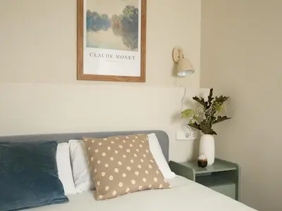 a bedroom with a bed and a picture on the wall at Casa Cosi El Farro 4 in Barcelona