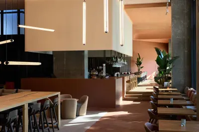 a restaurant with wooden tables and chairs and a bar at Barcelona Princess in Barcelona
